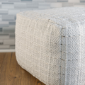 Striped woven pouf lifestyle shot in living room
