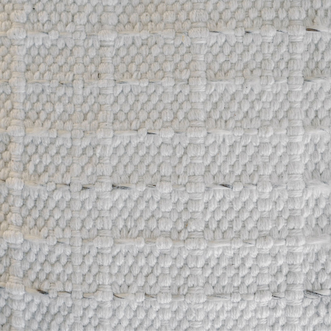 Close-up of striped woven pattern on ottoman pouf